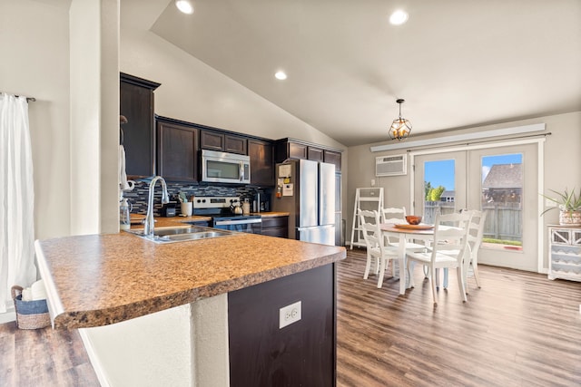 4961 Savannah St, Rapid City, SD 57703 - kitchen featuring appliances with stainless steel finishes, a sink, vaulted ceiling, french doors, and wood finished floors