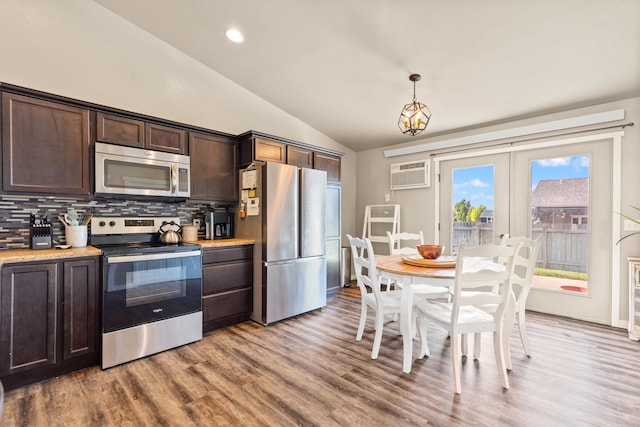 4961 Savannah St, Rapid City, SD 57703 - kitchen with appliances with stainless steel finishes, lofted ceiling, dark brown cabinets, decorative backsplash, and a wall mounted air conditioner