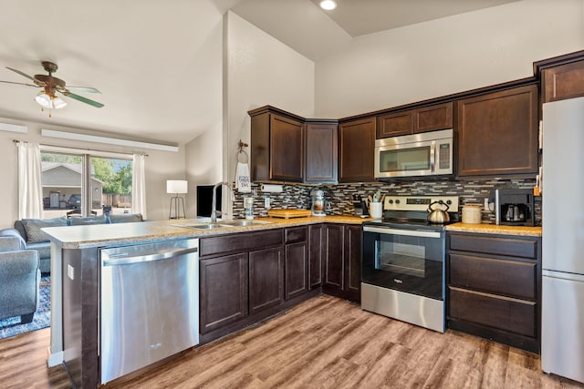 4961 Savannah St, Rapid City, SD 57703 - kitchen featuring stainless steel appliances, a sink, open floor plan, dark brown cabinets, and ceiling fan