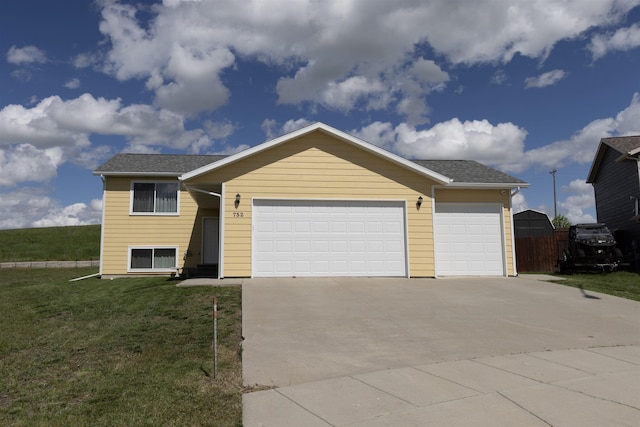 752 Bear Tooth Ct, Box Elder, SD 57719 - view of front facade with an attached garage, concrete driveway, a front yard, and roof with shingles