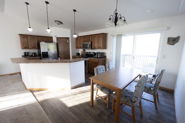 752 Bear Tooth Ct, Box Elder, SD 57719 - kitchen with stainless steel appliances, dark countertops, a chandelier, and baseboards