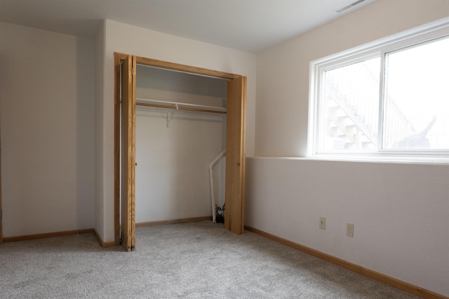 752 Bear Tooth Ct, Box Elder, SD 57719 - unfurnished bedroom featuring light colored carpet, a closet, and baseboards