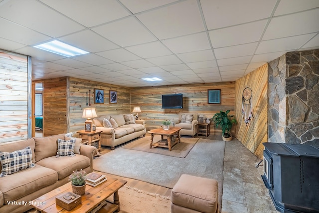 23470 Mineral Ln, Hill City, SD 57745 - living area featuring wood walls, a wood stove, and a drop ceiling