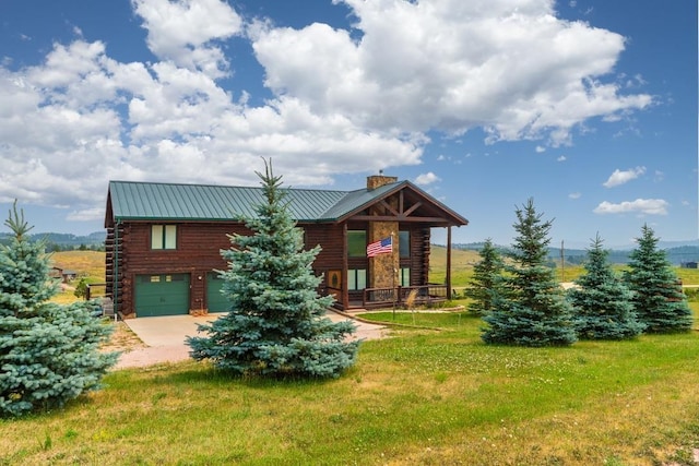 23470 Mineral Ln, Hill City, SD 57745 - log home with a chimney, log exterior, concrete driveway, and a garage