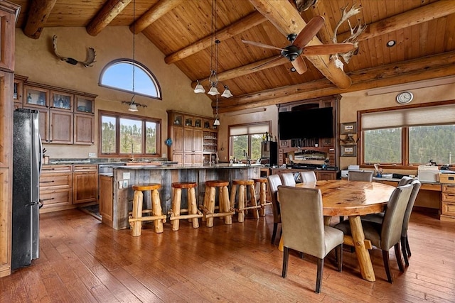 22231 Nahant Rd, Lead, SD 57754 - dining area with wooden ceiling with exposed beams, hardwood / wood-style flooring, high vaulted ceiling, and ceiling fan