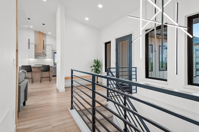 13439 Frontier Loop, Piedmont, SD 57769 - hallway featuring an upstairs landing, light wood-style floors, recessed lighting, and high vaulted ceiling