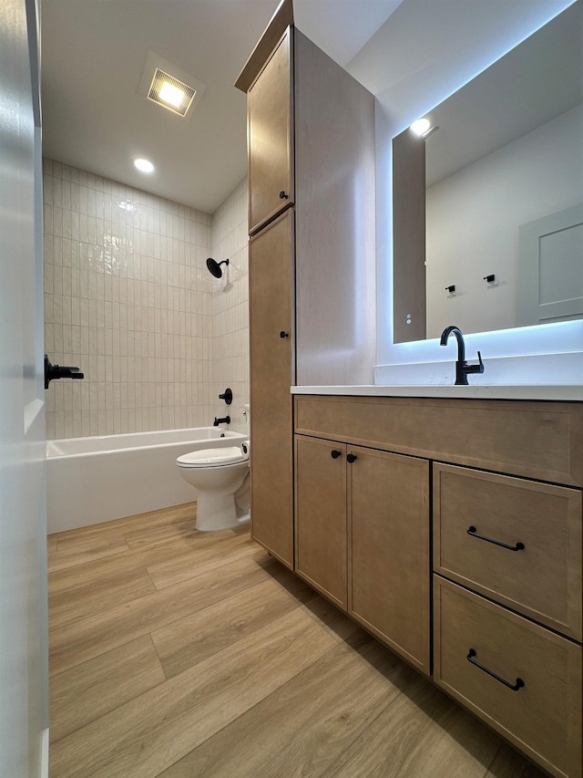 13439 Frontier Loop, Piedmont, SD 57769 - full bathroom featuring toilet, vanity, wood finished floors, and bathing tub / shower combination