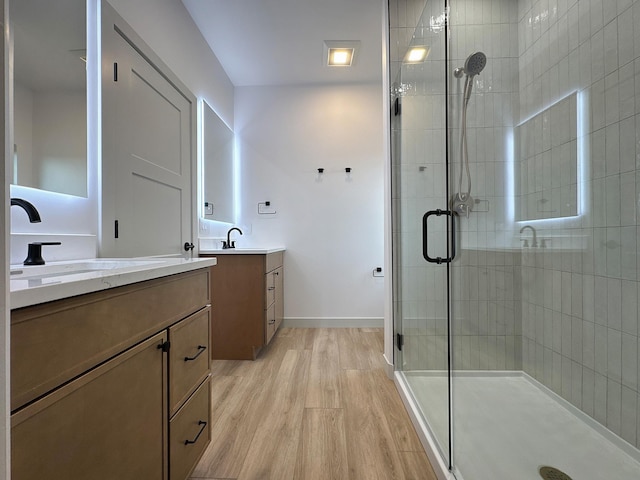 13439 Frontier Loop, Piedmont, SD 57769 - full bath featuring a shower stall, wood finished floors, two vanities, and baseboards