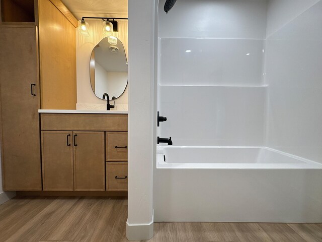 13439 Frontier Loop, Piedmont, SD 57769 - full bathroom featuring wood finished floors, vanity, and shower / tub combination