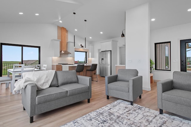 13439 Frontier Loop, Piedmont, SD 57769 - living room featuring high vaulted ceiling, light wood-style floors, and recessed lighting