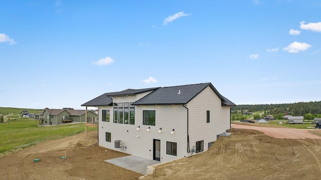 13439 Frontier Loop, Piedmont, SD 57769 - back of property featuring a shingled roof and a patio area