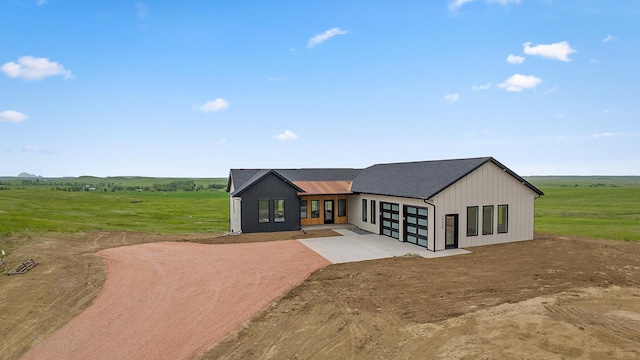 13439 Frontier Loop, Piedmont, SD 57769 - view of front facade featuring driveway, an attached garage, and a view of rural / pastoral area