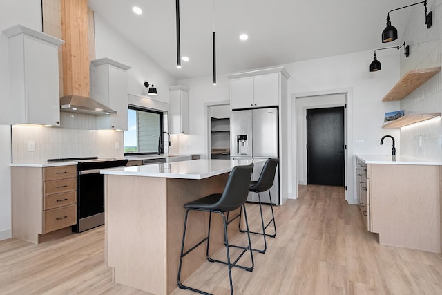13439 Frontier Loop, Piedmont, SD 57769 - kitchen featuring stove, stainless steel refrigerator with ice dispenser, open shelves, a kitchen island, and a kitchen breakfast bar