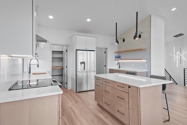 13439 Frontier Loop, Piedmont, SD 57769 - kitchen with stainless steel refrigerator with ice dispenser, a sink, light wood finished floors, a kitchen island, and light countertops