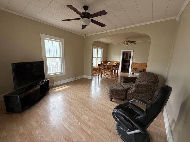 304 6th Ave, Edgemont, SD 57735 - living area with arched walkways, crown molding, ceiling fan, wood finished floors, and baseboards