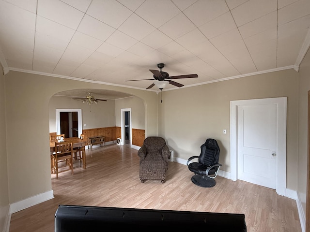 304 6th Ave, Edgemont, SD 57735 - sitting room with arched walkways, a ceiling fan, ornamental molding, wood finished floors, and wainscoting