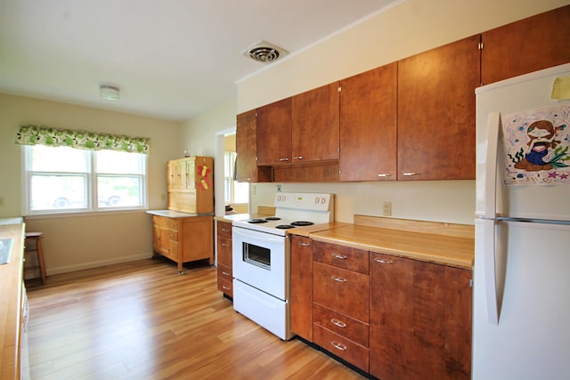 1033 Boulevard St, Sturgis, SD 57785 - kitchen featuring white appliances, light wood-style floors, light countertops, brown cabinetry, and baseboards