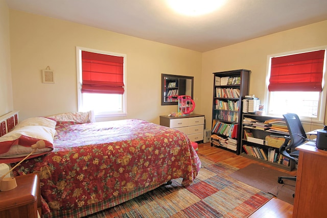 1033 Boulevard St, Sturgis, SD 57785 - bedroom featuring multiple windows, wood finished floors, and an office area