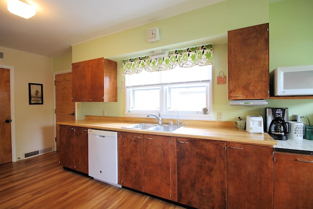 1033 Boulevard St, Sturgis, SD 57785 - kitchen featuring white appliances, light wood-type flooring, a sink, and light countertops