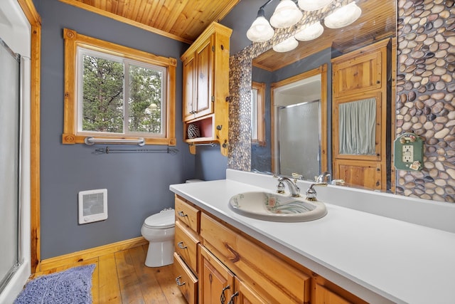 25370 S Lightning Creek Rd, Custer, SD 57730 - bathroom with heating unit, crown molding, baseboards, a shower with door, and vanity