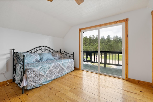 25370 S Lightning Creek Rd, Custer, SD 57730 - bedroom featuring vaulted ceiling, access to outside, hardwood / wood-style floors, baseboards, and a ceiling fan