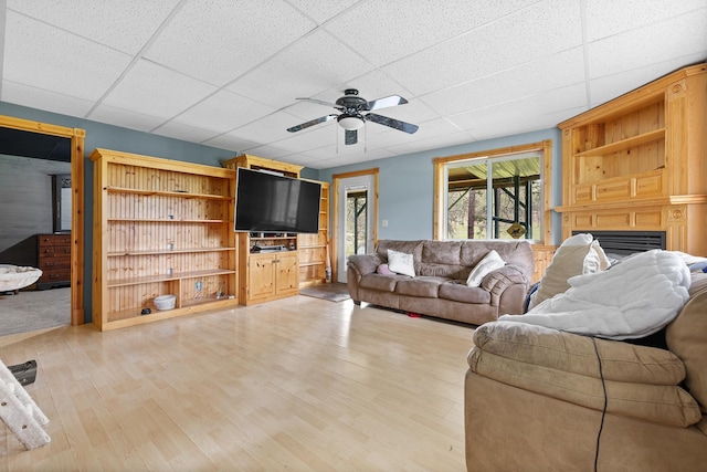 25370 S Lightning Creek Rd, Custer, SD 57730 - living area featuring a drop ceiling, ceiling fan, a fireplace, and light wood finished floors