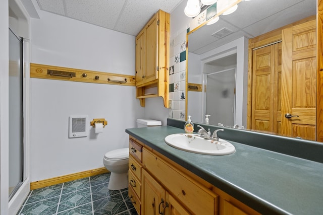 25370 S Lightning Creek Rd, Custer, SD 57730 - bathroom featuring a drop ceiling, a stall shower, vanity, toilet, and heating unit