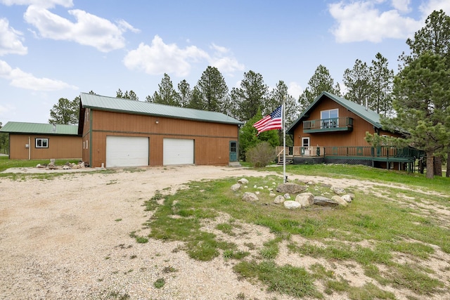 25370 S Lightning Creek Rd, Custer, SD 57730 - view of front of property featuring a detached garage, metal roof, a wooden deck, and an outbuilding