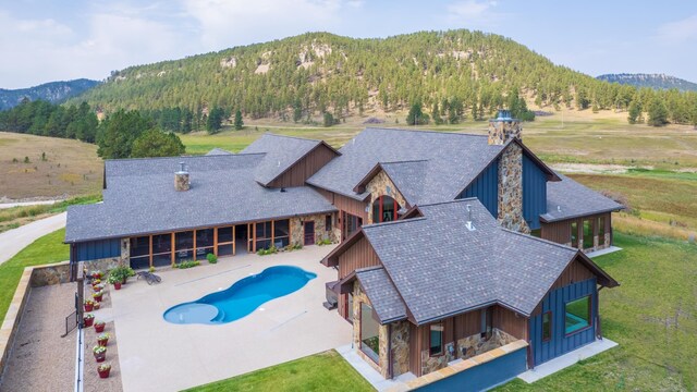 11753 Pleasant Valley Rd, Custer, SD 57730 - swimming pool featuring a mountain view, a yard, and a patio area