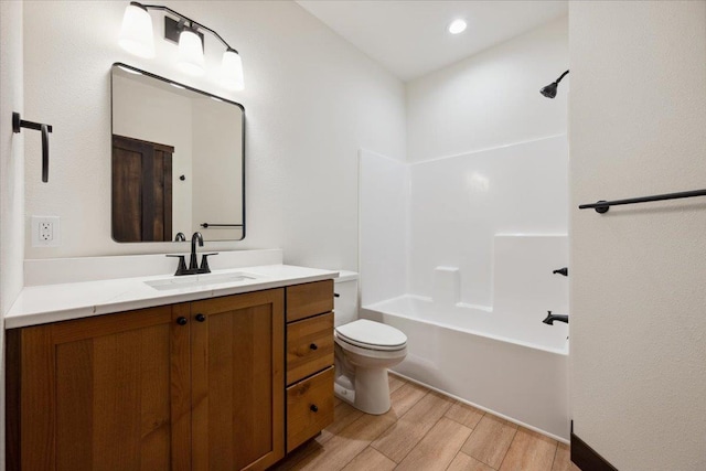 2431 Malibu Loop, Sturgis, SD 57785 - bathroom featuring vanity, toilet, wood finished floors, and bathing tub / shower combination