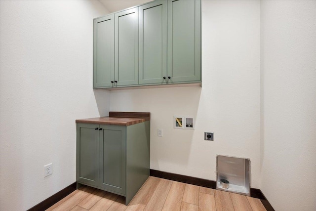 2431 Malibu Loop, Sturgis, SD 57785 - laundry area featuring electric dryer hookup, baseboards, cabinet space, light wood finished floors, and washer hookup