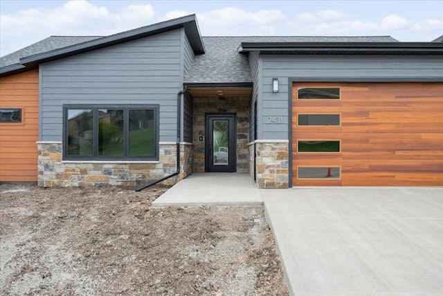 2431 Malibu Loop, Sturgis, SD 57785 - contemporary home with stone siding, a garage, and a shingled roof