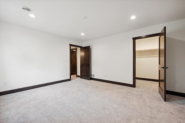 2431 Malibu Loop, Sturgis, SD 57785 - unfurnished bedroom featuring light colored carpet, a walk in closet, baseboards, and recessed lighting