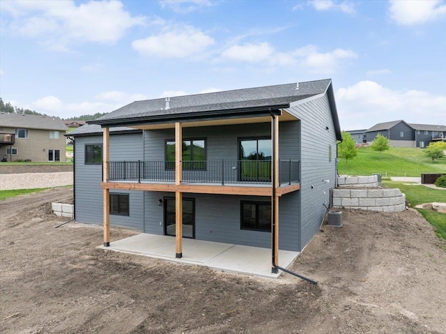 2431 Malibu Loop, Sturgis, SD 57785 - back of property with a balcony, a patio, central air condition unit, and a residential view