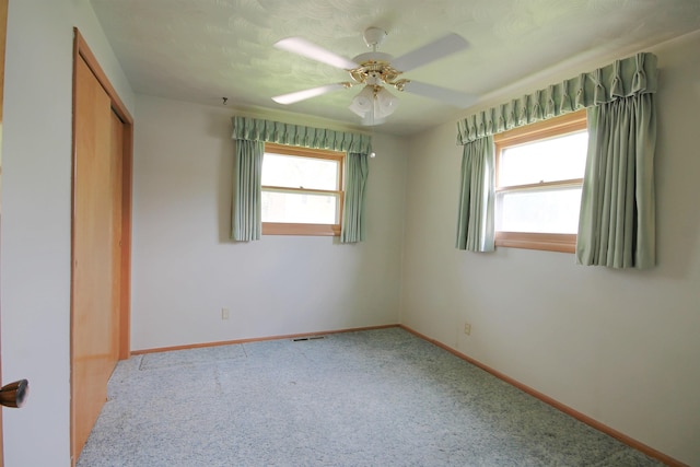 1609 Spruce St, Sturgis, SD 57785 - unfurnished bedroom with carpet floors, baseboards, a closet, and a ceiling fan