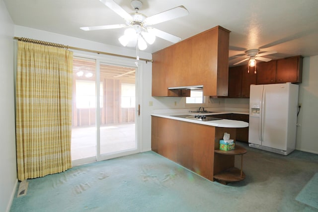 1609 Spruce St, Sturgis, SD 57785 - kitchen featuring white refrigerator with ice dispenser, a sink, a ceiling fan, a peninsula, and under cabinet range hood