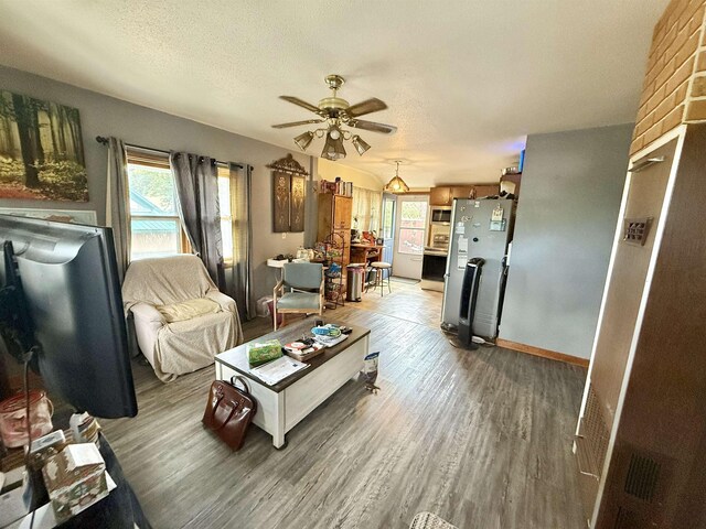 403 Mcquillan Ave, Lead, SD 57754 - living room with a ceiling fan, light wood-type flooring, a textured ceiling, and baseboards