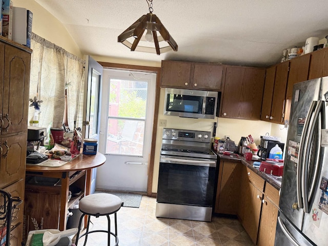 403 Mcquillan Ave, Lead, SD 57754 - kitchen with appliances with stainless steel finishes, dark countertops, and vaulted ceiling