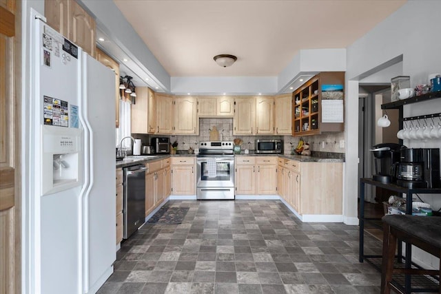 824 W Mcclellan St, Lead, SD 57754 - kitchen with appliances with stainless steel finishes, dark countertops, light brown cabinetry, and backsplash