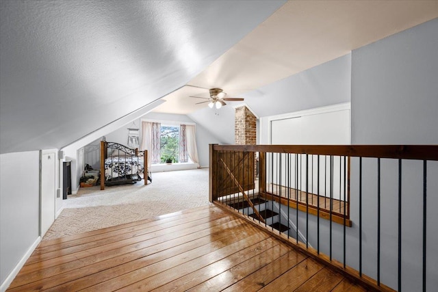824 W Mcclellan St, Lead, SD 57754 - additional living space featuring wood-type flooring, a ceiling fan, vaulted ceiling, and baseboards