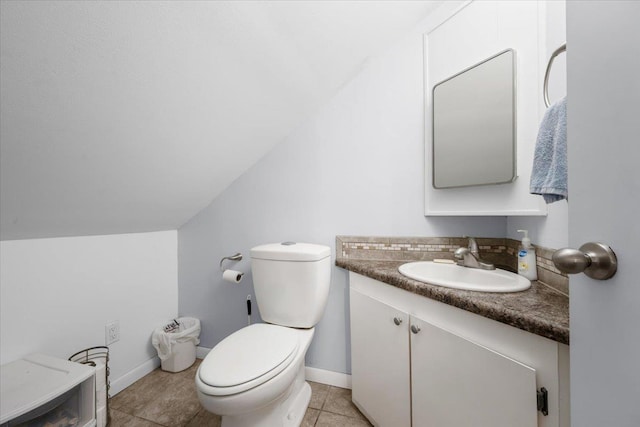 824 W Mcclellan St, Lead, SD 57754 - bathroom featuring vanity, toilet, lofted ceiling, baseboards, and tile patterned floors
