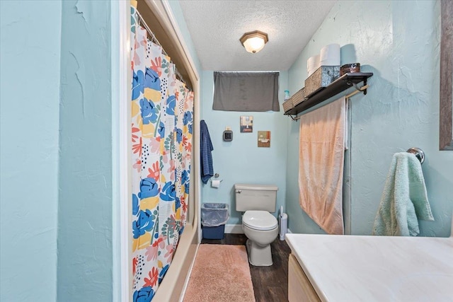 824 W Mcclellan St, Lead, SD 57754 - bathroom featuring a textured ceiling, toilet, wood finished floors, and vanity