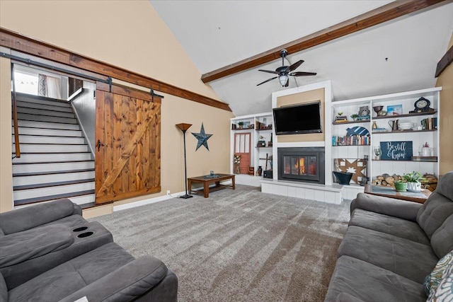 824 W Mcclellan St, Lead, SD 57754 - living room with stairs, ceiling fan, beamed ceiling, carpet flooring, and a glass covered fireplace