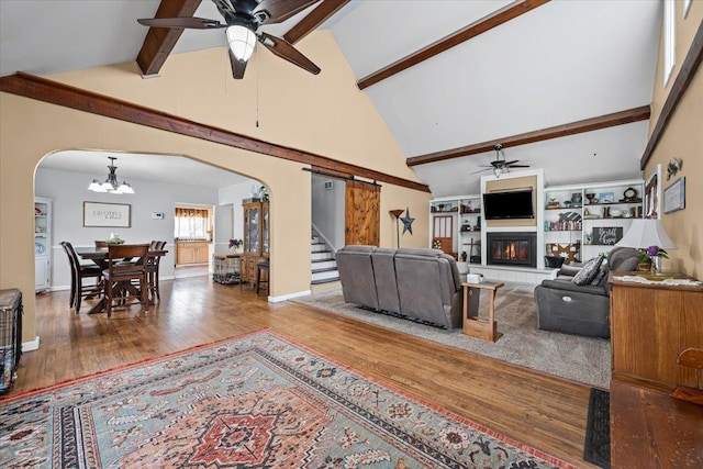 824 W Mcclellan St, Lead, SD 57754 - living area featuring a ceiling fan, arched walkways, high vaulted ceiling, beam ceiling, and wood finished floors