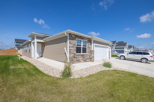 503 Aaron Ct, Rapid City, SD 57703 - view of side of home featuring driveway, an attached garage, and stone siding