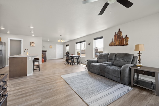 503 Aaron Ct, Rapid City, SD 57703 - living room featuring light wood-style floors, recessed lighting, ceiling fan, baseboards, and a chandelier