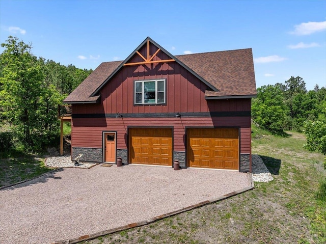 15377 Ridgeview Trl, Piedmont, SD 57783 - view of front facade with stone siding, roof with shingles, gravel driveway, and board and batten siding