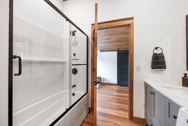15377 Ridgeview Trl, Piedmont, SD 57783 - bathroom featuring bath / shower combo with glass door, wood finished floors, and vanity