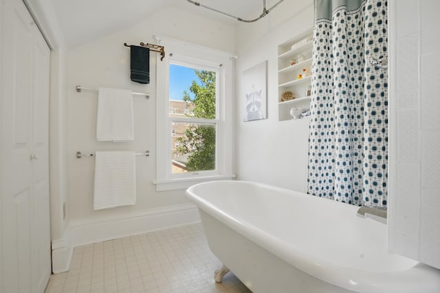 1015 W W Boulevard, St, Rapid City, SD 57701 - bathroom with a freestanding bath, curtained shower, and vaulted ceiling