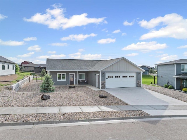 3781 W Beartooth Loop, Spearfish, SD 57783 - view of front facade with board and batten siding, an attached garage, concrete driveway, and stone siding